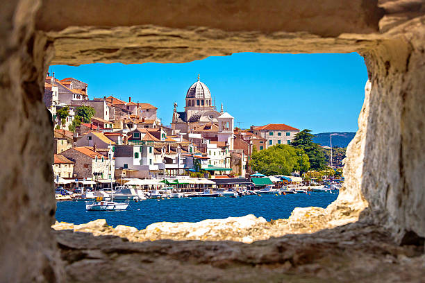 Sibenik waterfront through stone window view, Dalmatia, Croatia